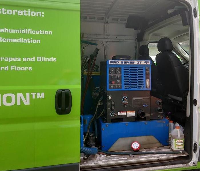 Picture of a SERVPRO van with a truck mounted carpet cleaning machine