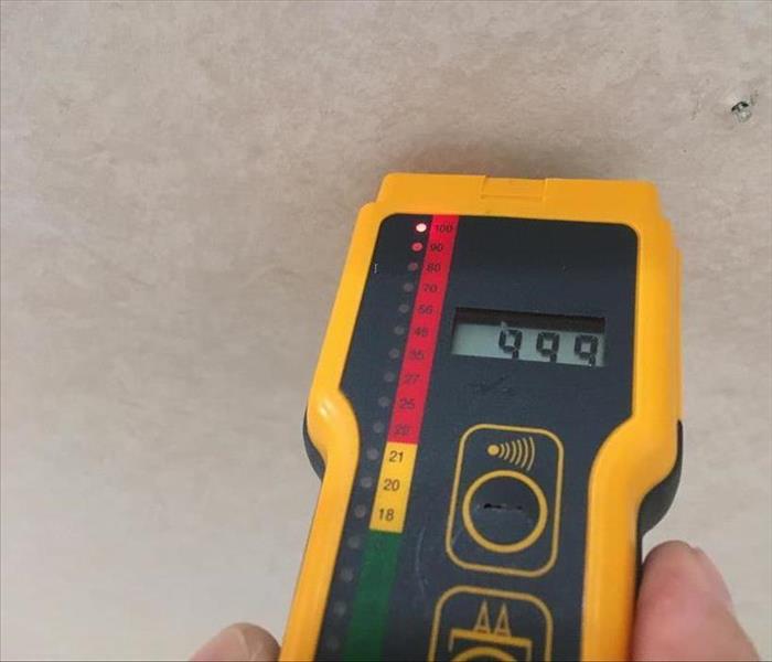 SERVPRO Professional With A Moisture Meter Finds Hidden Water In Wall