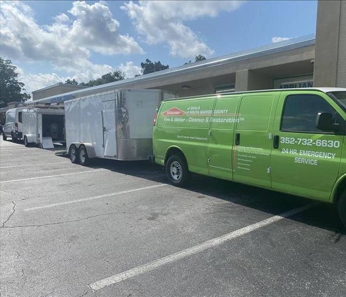 SERVPRO Duct Cleaning Van and Trailer in Front of a large commercial building 
